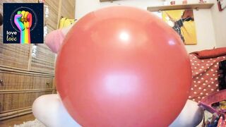 Pride 2021 Nicoletta inflates a large red balloon and rides it