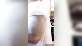 Aged woman in transparent granny night gown, natural melons