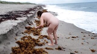Older big beautiful woman being stupid and walking on naked beach.