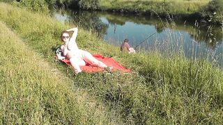 Wild beach. Hawt mother I'd like to fuck Platinum undressed sunbathing on river bank, random fisherman chap watches. Exposed in public. In Nature's Garb beach