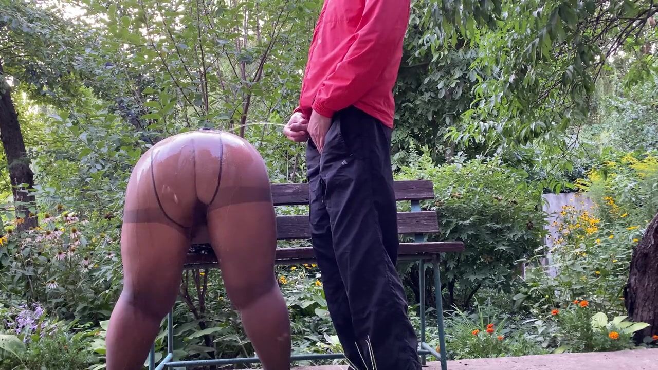 Double pissing stepmom in hose and stepson outdoors.