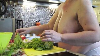 Housewife with large saggy titties crumbles salad in the kitchen.