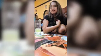 Aged lady showing her melons in public in a restaurant