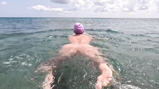 bare angel swims in the sea with vagina underwater