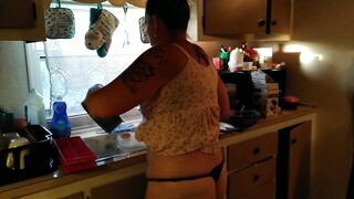 Showing off my cleavage and belt by lifting up my costume whilst cooking in kitchen
