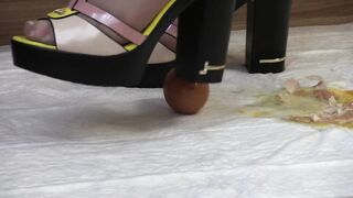 crashes eggs with high heels, aged lady in high-heeled shoes