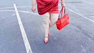 Gorgeous woman walking outdoors in public parking lot showing off for strangers