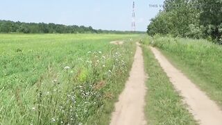 Gorgeous stripped walk in the wild: Naturist posing in a green spring field